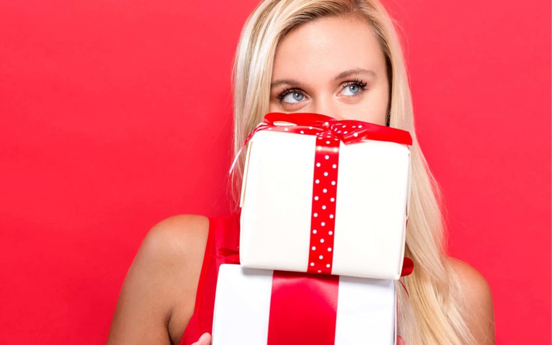 Woman holding a stack of gifts